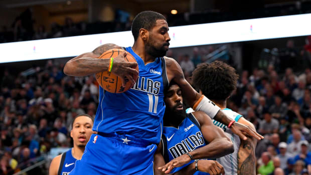 Kyrie Irving snags a rebound in the Dallas Mavericks’ win over the Charlotte Hornets on Sunday.